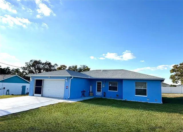 an aerial view of a house with outdoor space