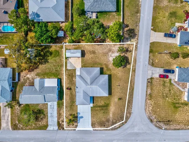 an aerial view of residential houses with outdoor space