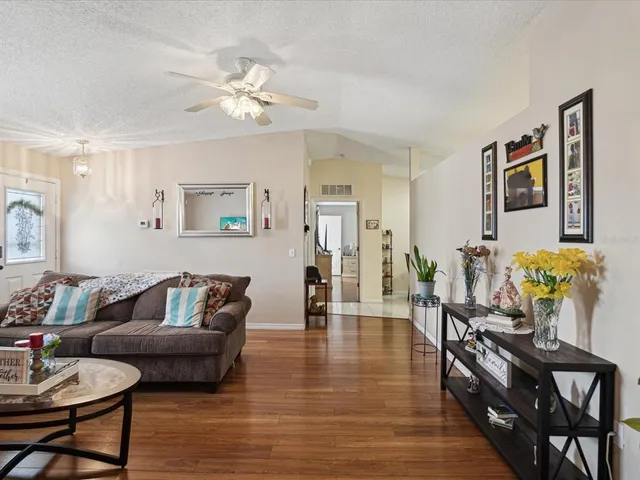 a living room with furniture and wooden floor