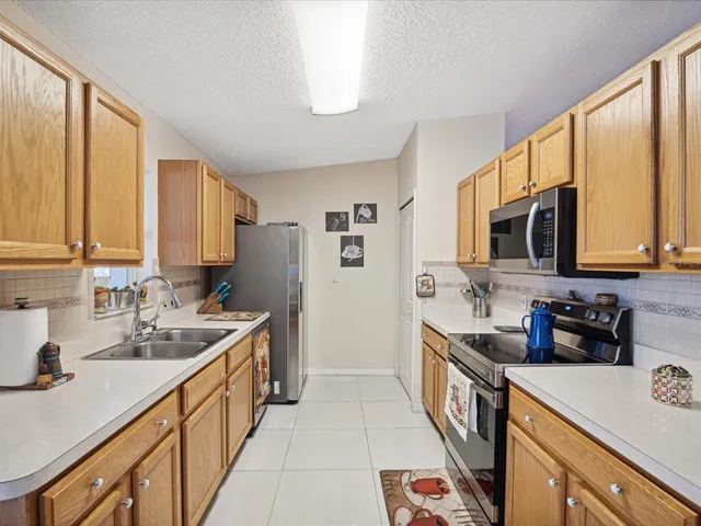 a kitchen with stainless steel appliances a sink stove and cabinets