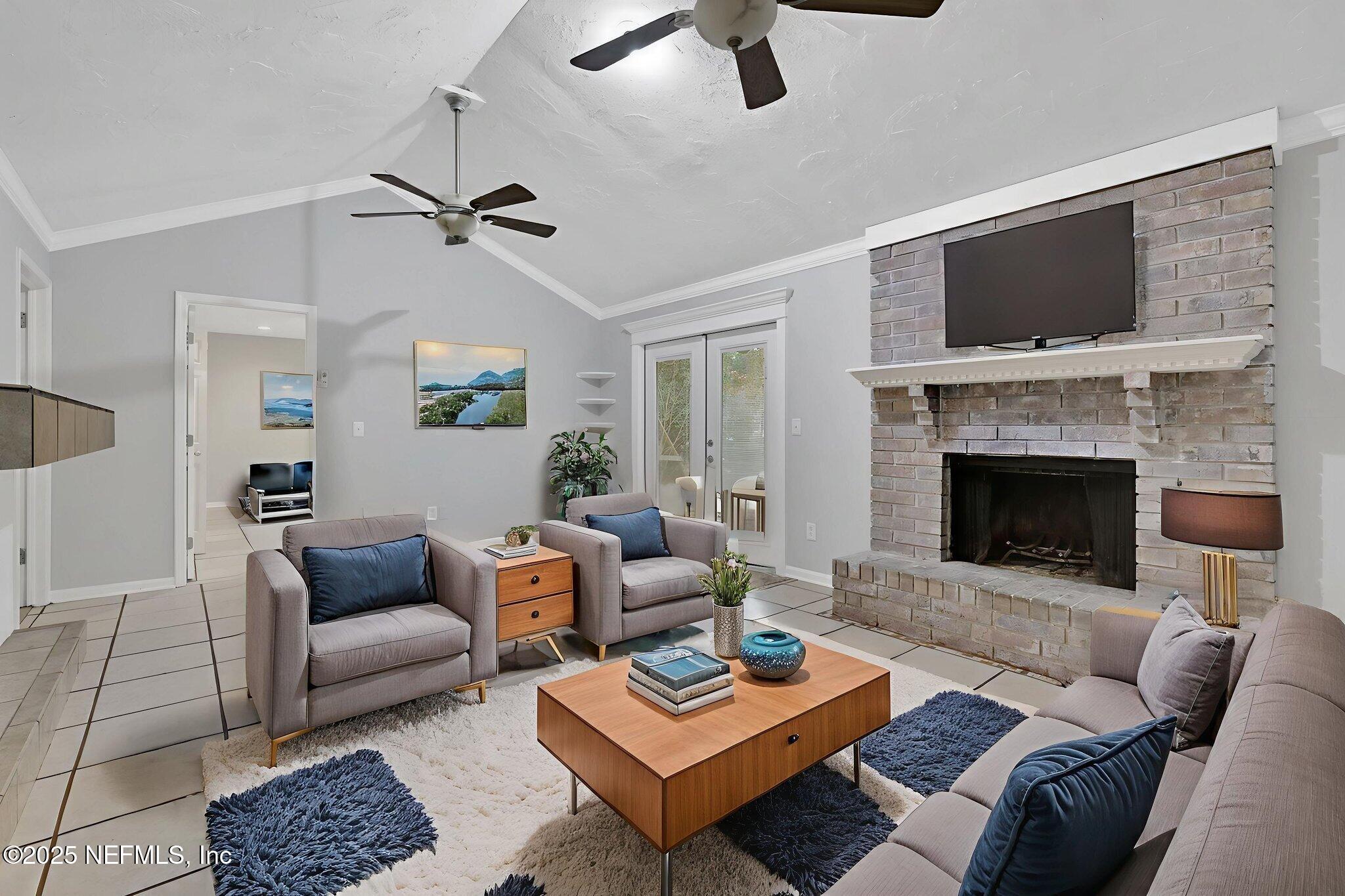 3452 North Ride Court Jacksonville, FL 32223 - Photo 13 of 39 a living room with furniture a flat screen tv and a fireplace