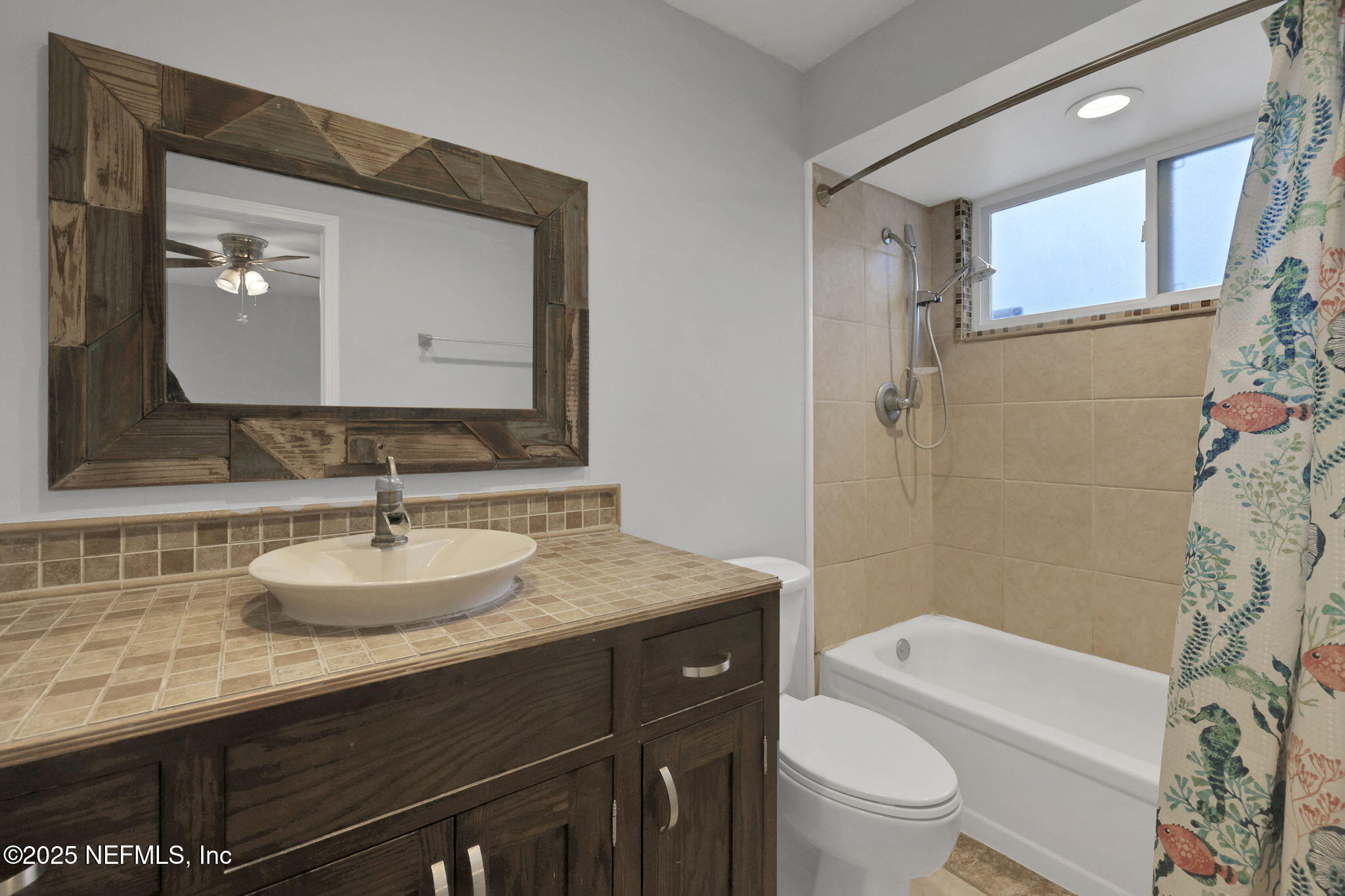 3452 North Ride Court Jacksonville, FL 32223 - Photo 17 of 39 a bathroom with a granite countertop sink toilet a mirror and shower