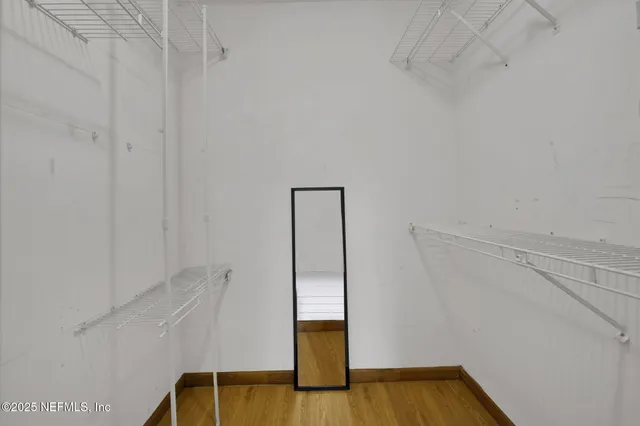 a bedroom with a bed a chandelier and a couch