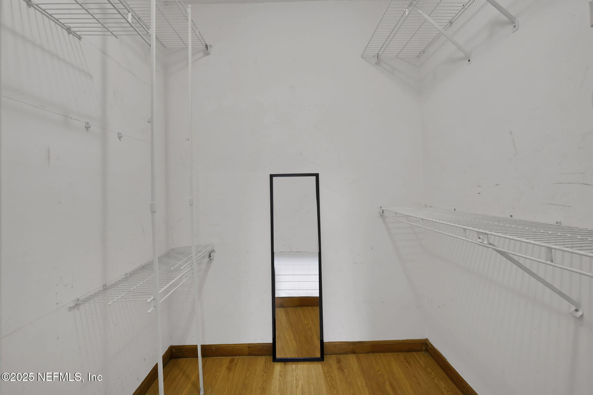 3452 North Ride Court Jacksonville, FL 32223 - Photo 18 of 39 a view of an empty room with wooden floor and a window