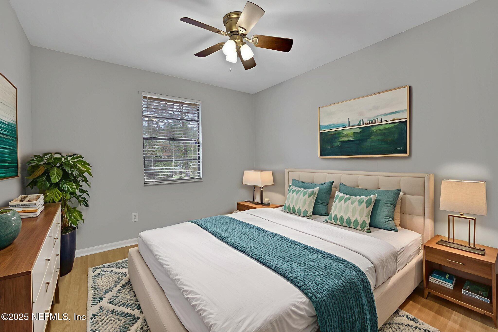 3452 North Ride Court Jacksonville, FL 32223 - Photo 22 of 39 a bedroom with bed and a chandelier