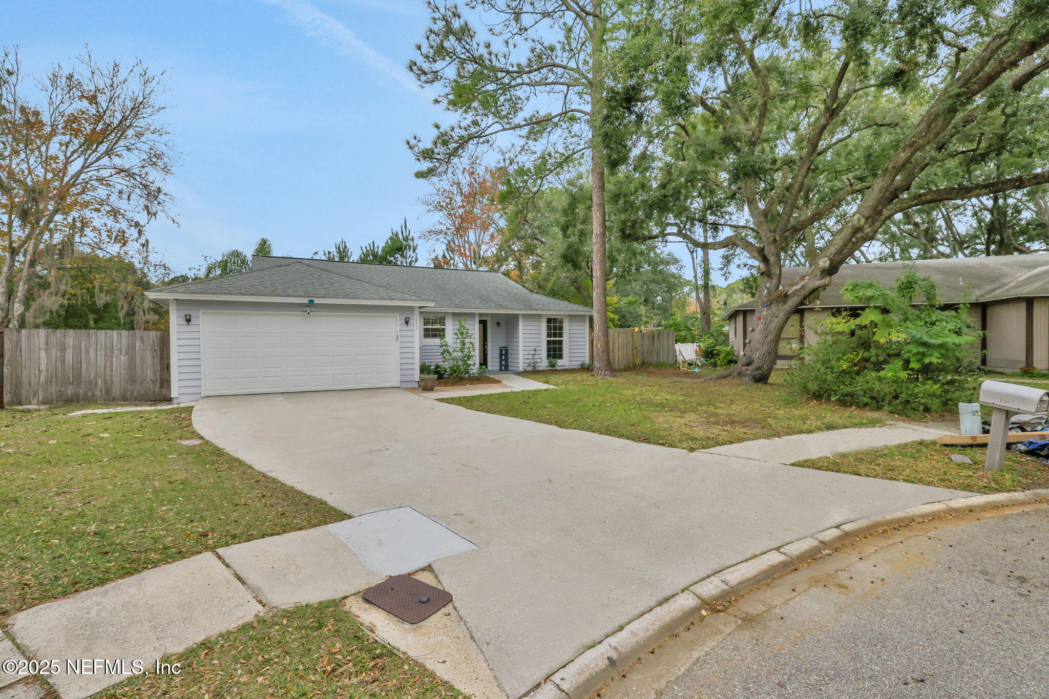 3452 North Ride Court Jacksonville, FL 32223 - Photo 39 of 39 a front view of a house with a garden and trees