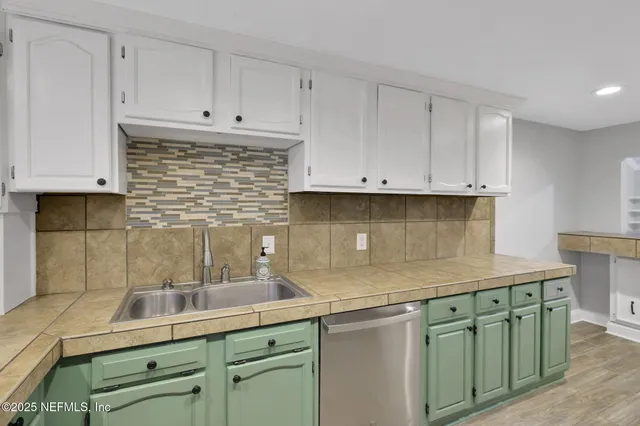 a kitchen with stainless steel appliances granite countertop a refrigerator and a stove