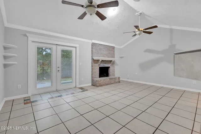 a view of an empty room with a fireplace and a rug