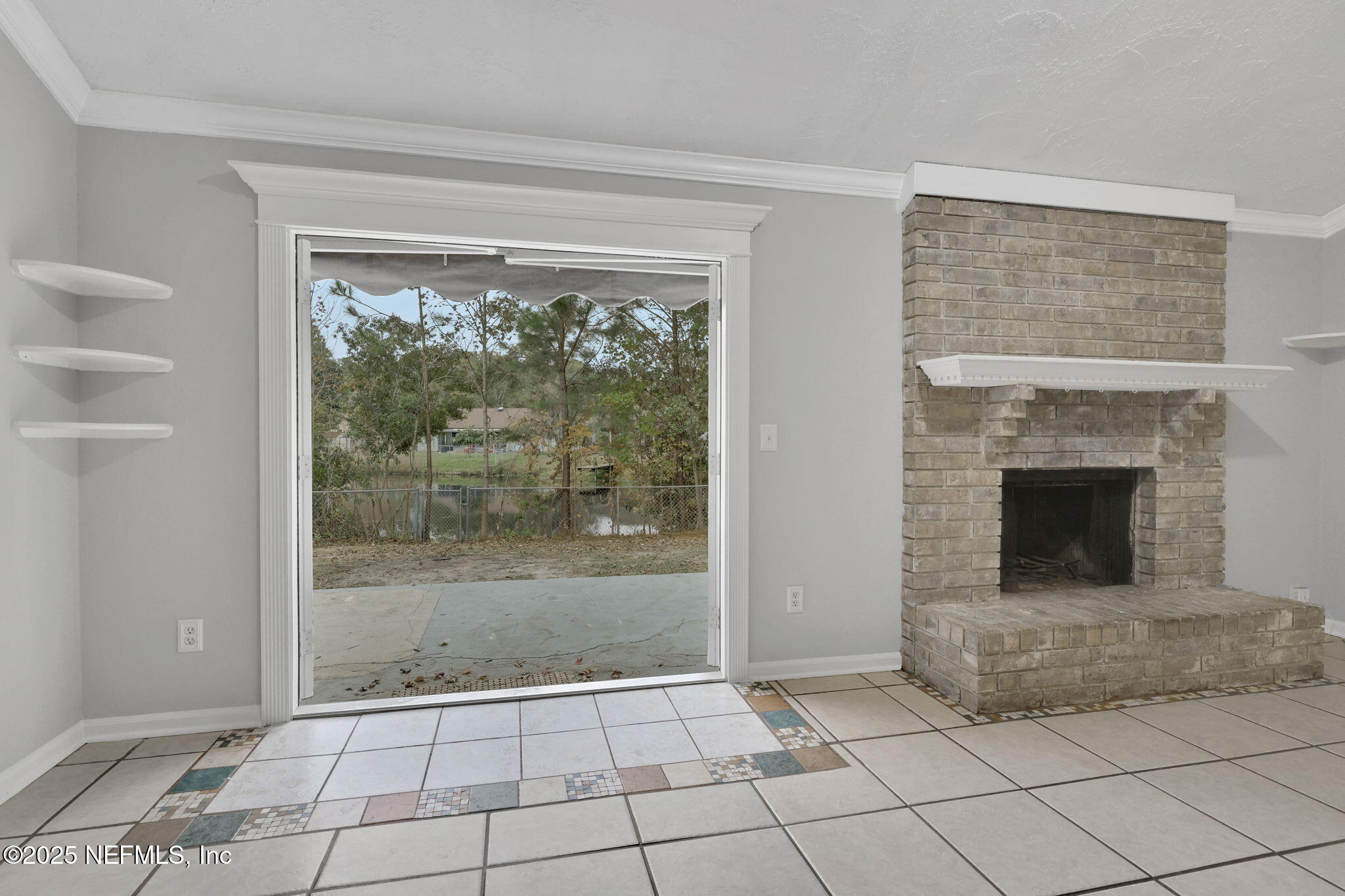 3452 North Ride Court Jacksonville, FL 32223 - Photo 9 of 39 a living room with a fireplace and a floor to ceiling window