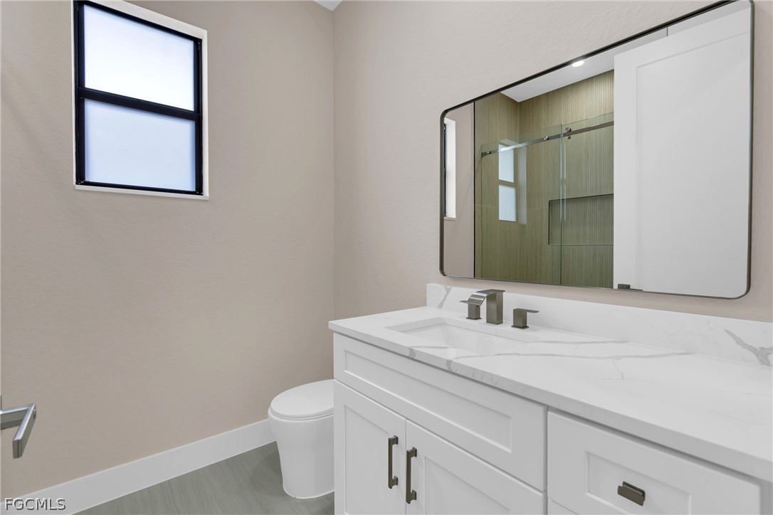 6029 Keystone Circle LaBelle, FL 33935 - Photo 27 of 50 a bathroom with a toilet sink and mirror
