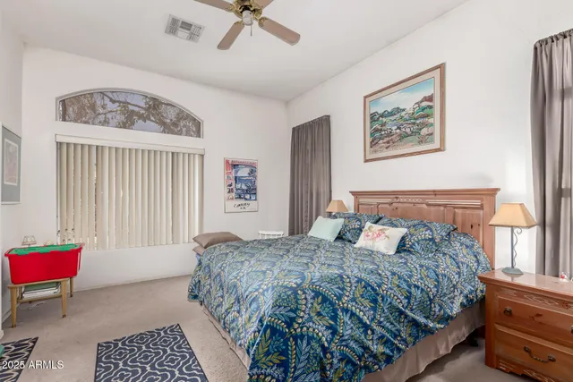 a bedroom with a bed dresser and a window