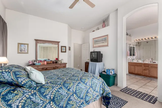 a bedroom with a bed and a view of living room