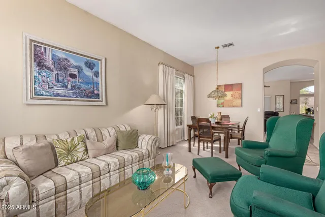 a living room with furniture a couch and a dining table