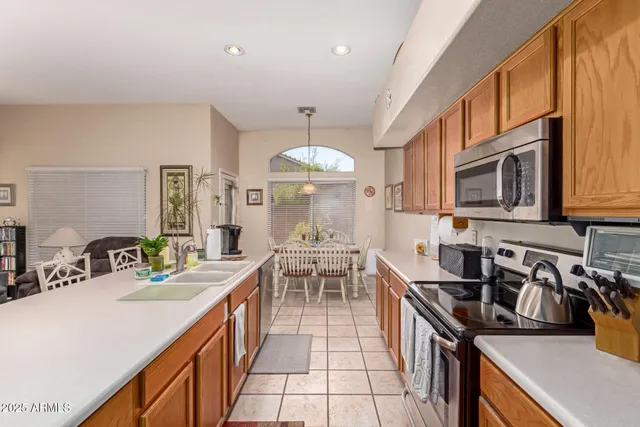 a kitchen with stainless steel appliances granite countertop a sink stove and cabinets