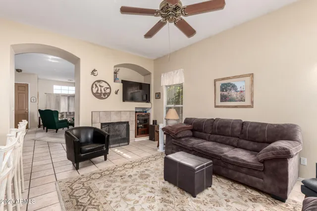 a living room with furniture ceiling fan and a rug