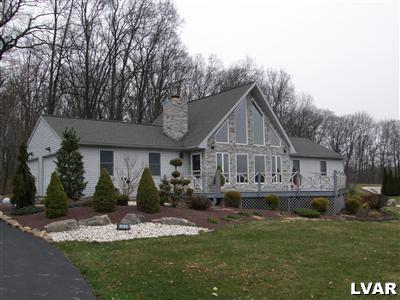 2302 Yost Road Bath, PA 18014 - Photo 1 of 12 a front view of a house with a garden and plants