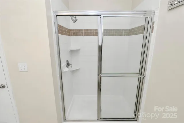 a bathroom with a glass shower door
