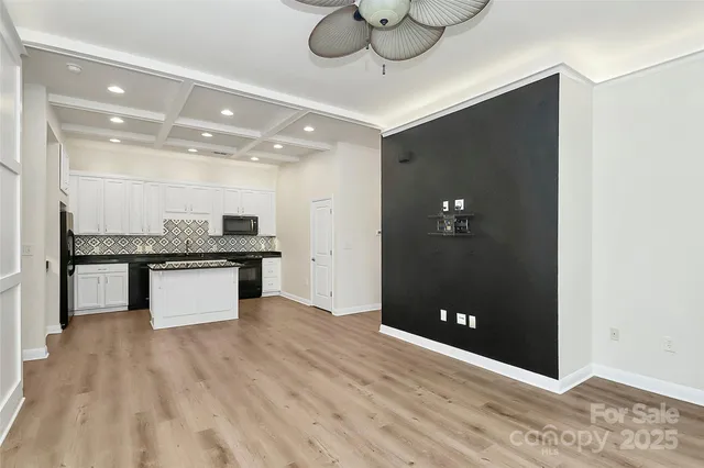 a view of kitchen with refrigerator and microwave