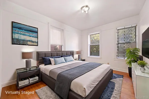 a bedroom with bed and a potted plant