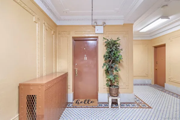 a room that has a window and a potted plant