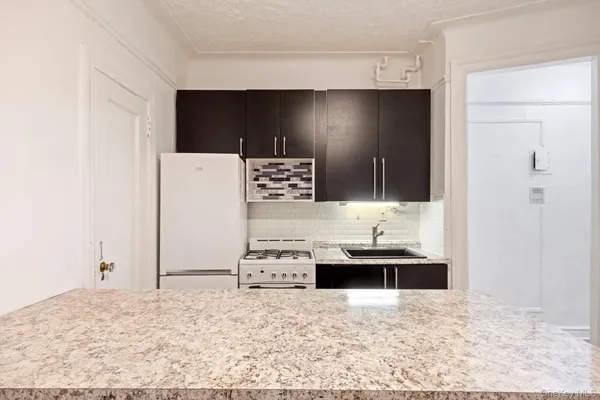 a kitchen with a sink and a stove top oven