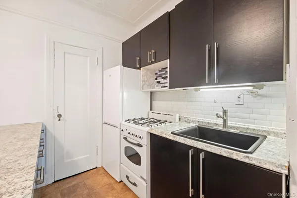 a utility room with sink dryer and washer