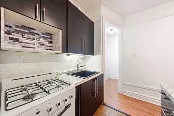 a kitchen with sink and cabinets