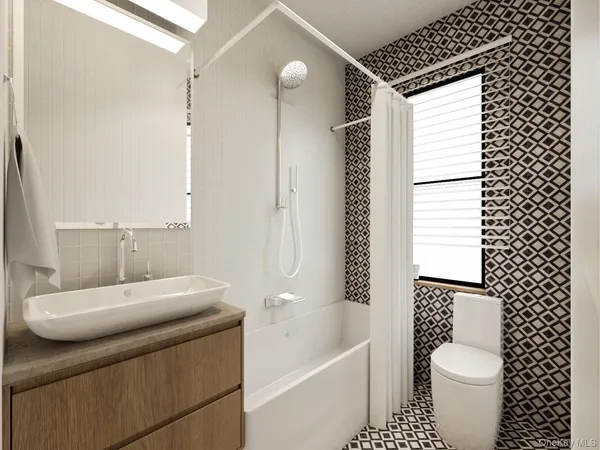 a bathroom with a toilet a sink and bathtub