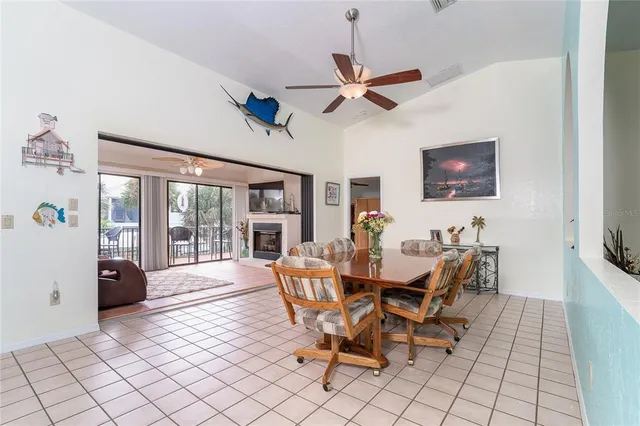 a living room with furniture a fireplace and a large window