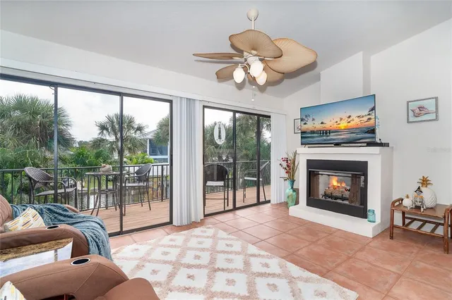 a dining room with furniture a floor to ceiling window and wooden floor