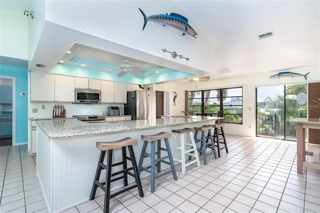 a kitchen with stainless steel appliances granite countertop a sink and cabinets