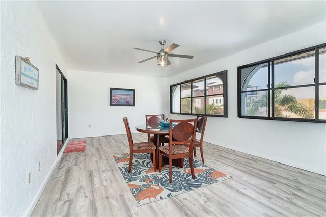 a bedroom with a large bed a chandelier and a window