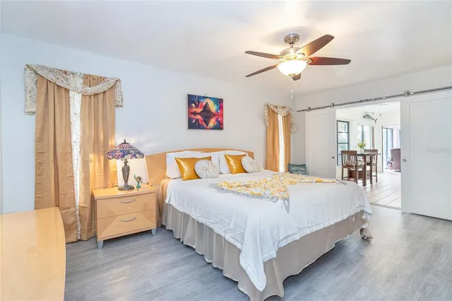 a bedroom with a bed and a chandelier