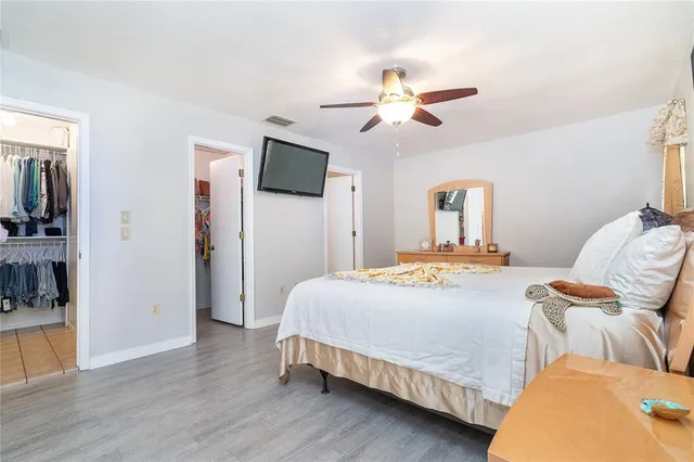 a spacious bathroom with a granite countertop sink a mirror a vanity and a shower
