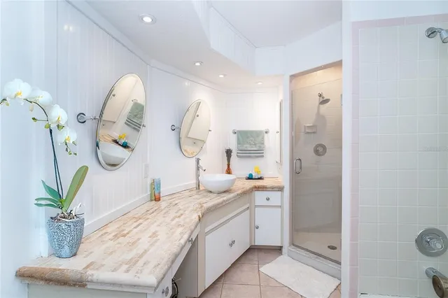 a bathroom with a granite countertop sink a toilet and shower