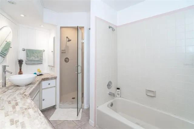 a bedroom with a bed and a large mirror with a chandelier