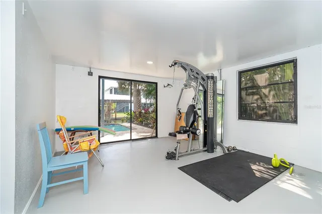 a dining room with furniture and a floor to ceiling window