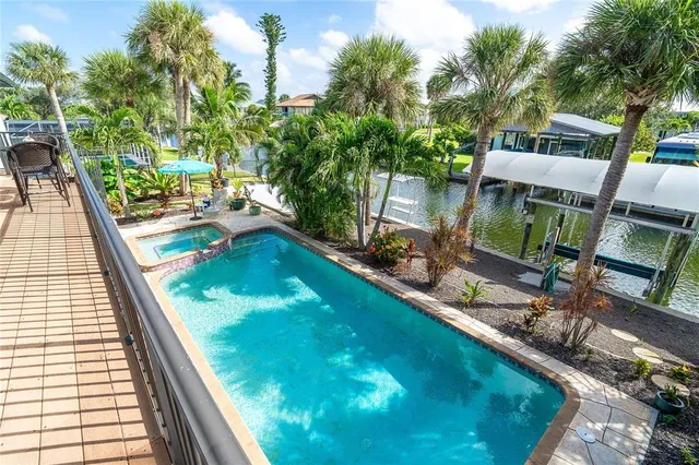 a view of a house with backyard water fountain and sitting area