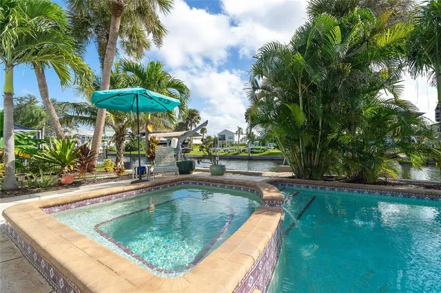 an aerial view of ocean and residential houses with outdoor space