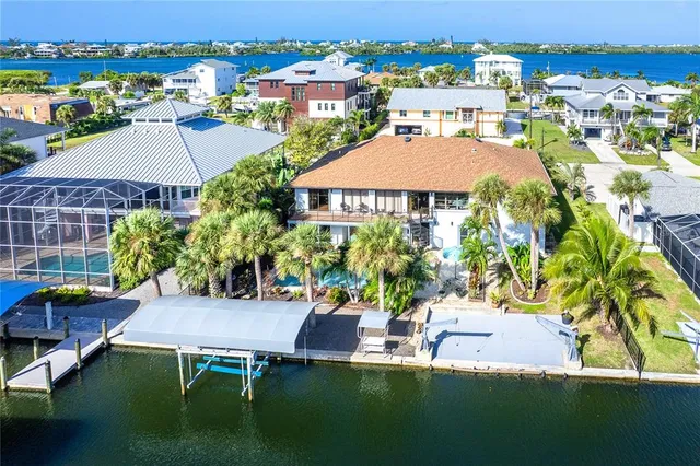 an aerial view of a house with swimming pool patio and outdoor seating