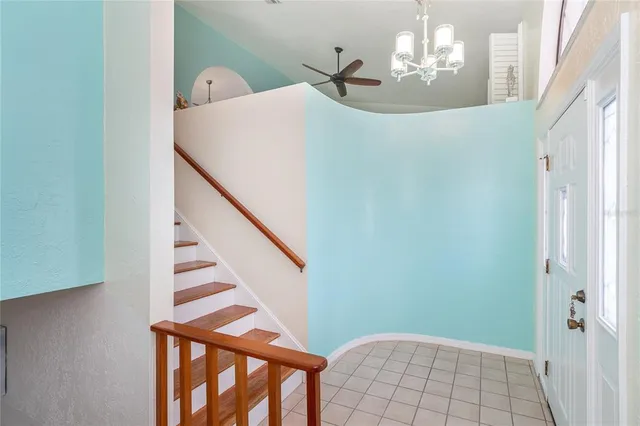 a living room with furniture a ceiling fan and a window