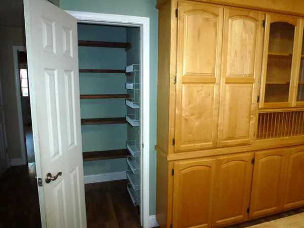 a view of a hallway with wooden floor and stairs