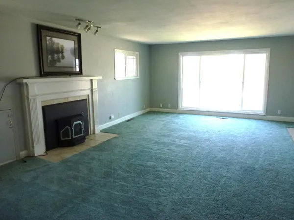 a living room with a fireplace and a flat screen tv