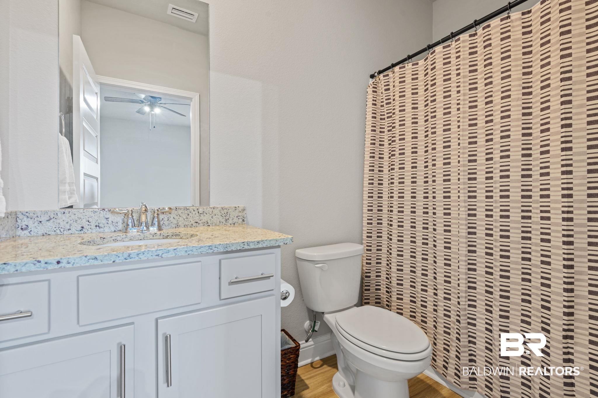 2183 Meadowview Loop Semmes, AL 36575 - Photo 28 of 58 Full bath featuring vanity, light wood-style floors, and curtained shower