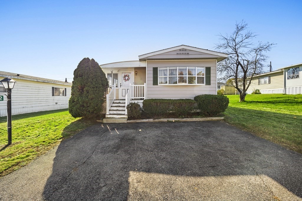 102 Peter Street Raynham, MA 02767 - Photo 19 of 23 a front view of a house with a yard and garage