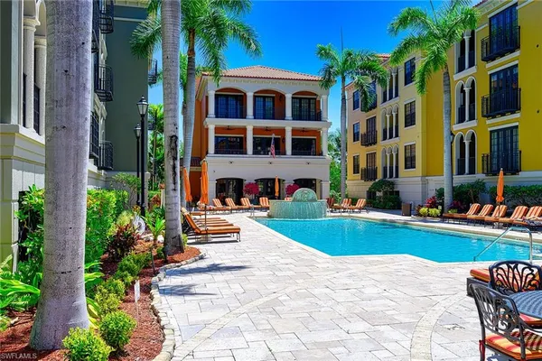 a front view of a house with swimming pool having outdoor seating