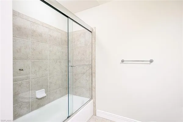 a bathroom with a glass shower door