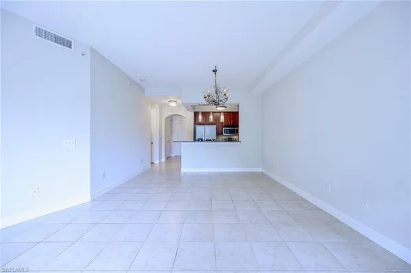 a view of a kitchen with a sink and chandelier