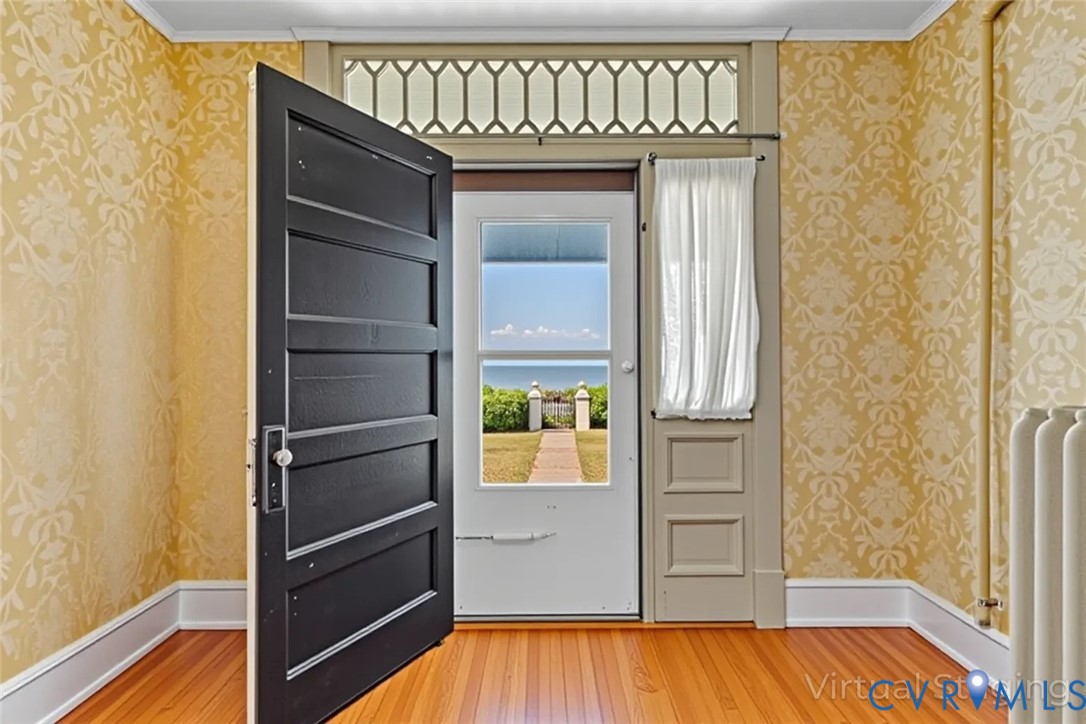 218 Fleeton Point Circle Reedville, VA 22539 - Photo 16 of 43 Entryway with wallpapered walls, wood-type floorin
