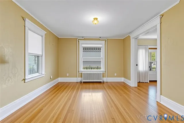 wooden floor in an empty room with a window